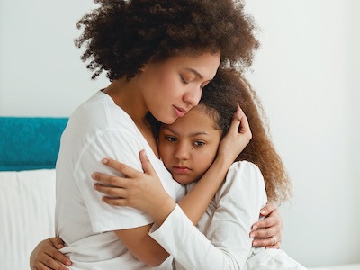 Mom embracing daughter after taking CPS defense legal advice to restore family by blair parker law in houston, texas.