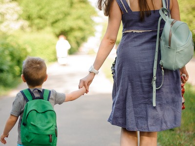 Mom walking with son after finding out more about what does non-custodial parent mean according to Texas law