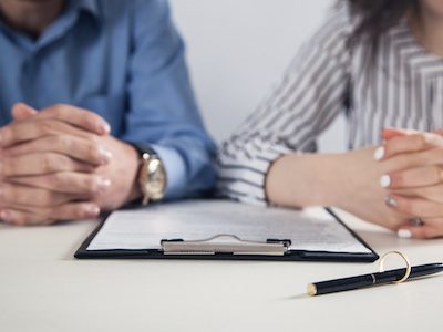 Husband and wife contemplate signing paperwork for legal separation in Texas