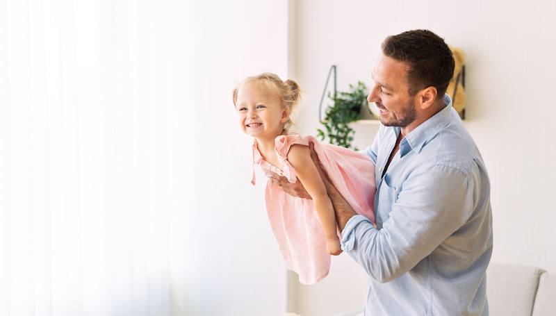 A father playing with his daughter after receiving full custody in Texas.