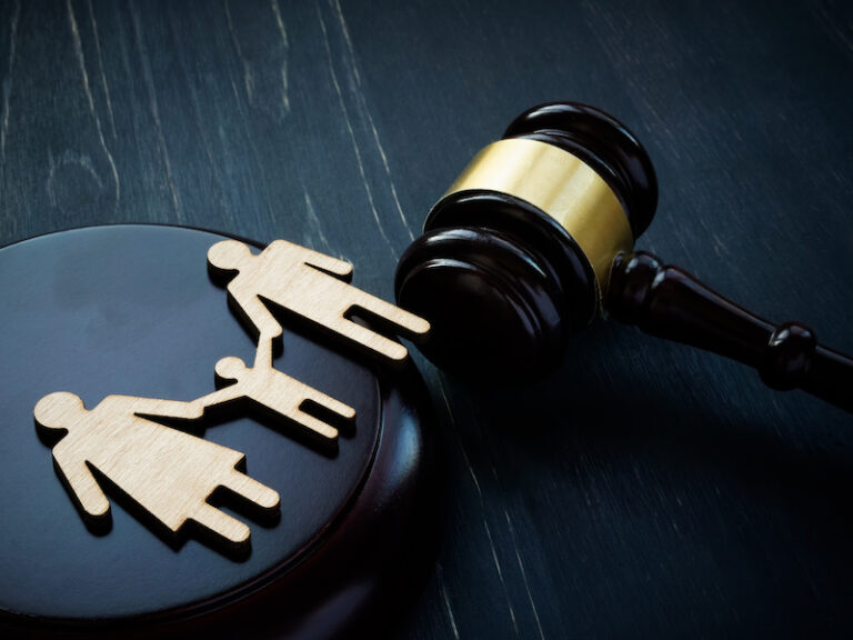 A family law attorney image with a gavel and family cutout on a table.