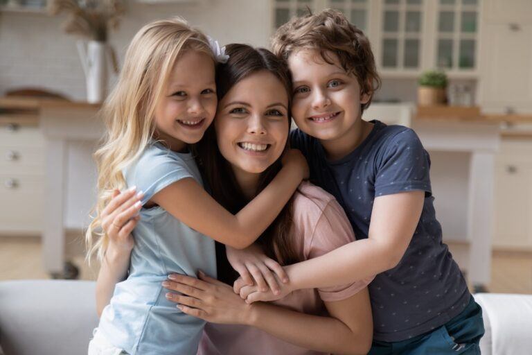 Mom and her children smiling after completing a family law modification