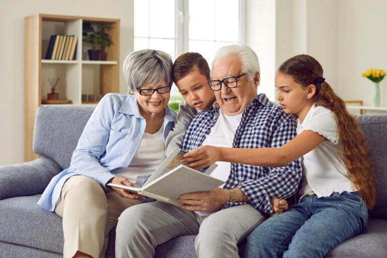 Grandparents reading a book to their grandchildren after adopting them