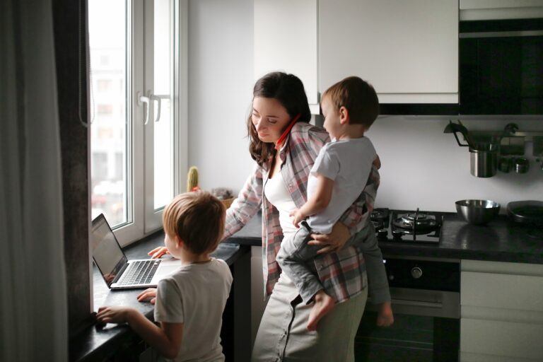 Mom in the kitchen with her children checking how to modify a temporary custody order