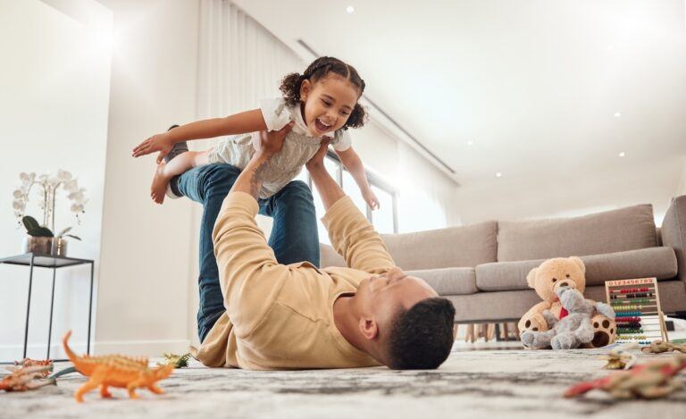 Father playing with daughter after completing the stepchild adoption process